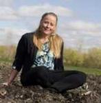 photo of Atina Diffley seated in a field
