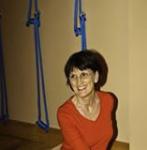 photo of Sandra Helpsmeet smiling and leading a Yoga class