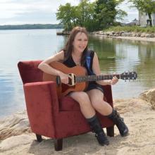 Marci Geller playing guitar