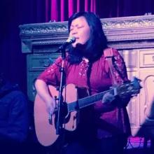 Frances Ancheta performing with her guitar