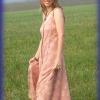 photo of Julie Rust wearing a long, sleeveless summer dress and standing in a field