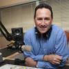 Ben sitting at microphone in studio